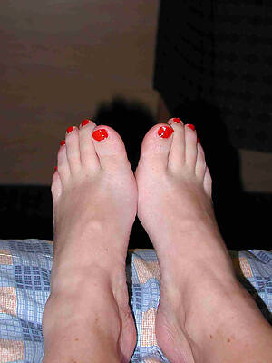 mature bare feet on bed photo