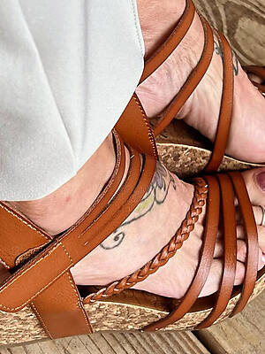 mature bare feet on bed